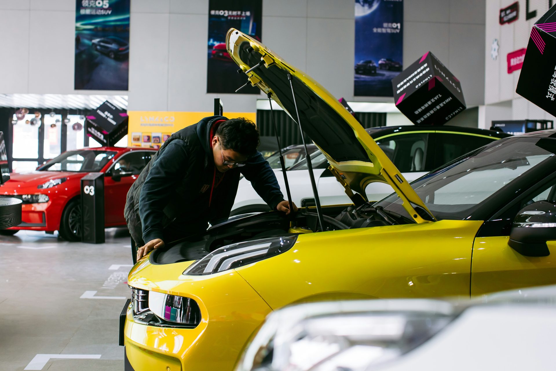 man in black jacket and black pants riding yellow car